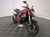 a picture of a red and black motorcycle parked on a checkered floor