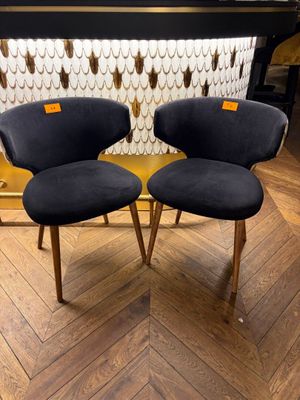 pair of mid century style chairs in black velvet upholstered with wooden legs