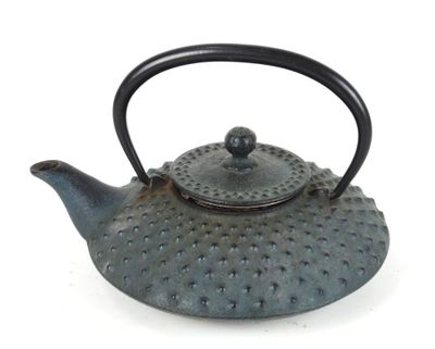 a tea pot with a handle on a white surface