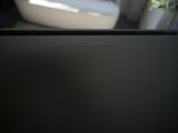 a laptop computer sitting on a table with a plant in the background