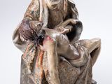 an image of a statue of a woman sitting on a man ' s lap