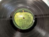 an old record with a label on it sitting on a table