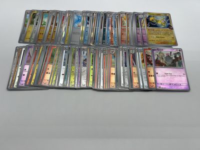 a large collection of pokemon cards sitting on top of a table