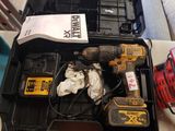 a box with a drill and two other tools in it