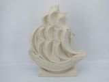 a white sculpture of a ship on a white background