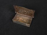 a small metal box on a black surface