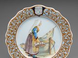 une image représentant une assiette décorative sur laquelle figure une femme dans un bateau