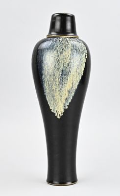 a black vase with a white and yellow design on it