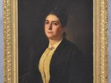 portrait of a woman in a black jacket and yellow shirt