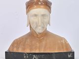marble bust of a man with a hat on a marble base