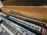 a piano that is sitting on top of a piano case