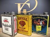 three tins that are sitting next to each other on a table