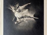 an old black and white photo of two dancers in the air