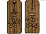 two military badges with a crown on them on a white background