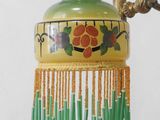 a lamp that is on a stand with a flower design on it