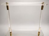a clear acrylic console table with gold accents