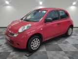 the small red car is parked in the garage on a checkered floor