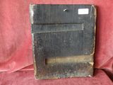a black piece of wood that is on a red cloth