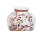 a vase with a floral design on it on a white surface