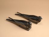 two black birds that are sitting on a table