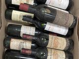 many bottles of wine in a box on the table