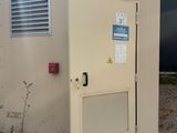 a door that has a sign on it in front of a building