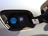 a close up of a car ' s fuel tank with a blue cap