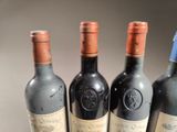 three bottles of wine are lined up on a table