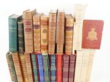 a lot of old books stacked on top of each other