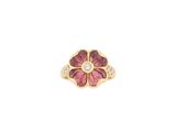 a close up of a pink flower ring with a diamond in the center