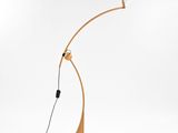 a wooden floor lamp with a white light on top of it