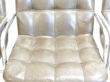 three silver leather chairs with chrome legs and a white background