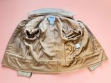 an image of a tan jacket with a tag on it on a pink background