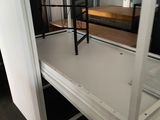 a room with a bed and a desk in it