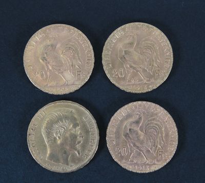 four different types of silver coins on a blue surface