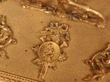 a gold plate with a picture of a man on it