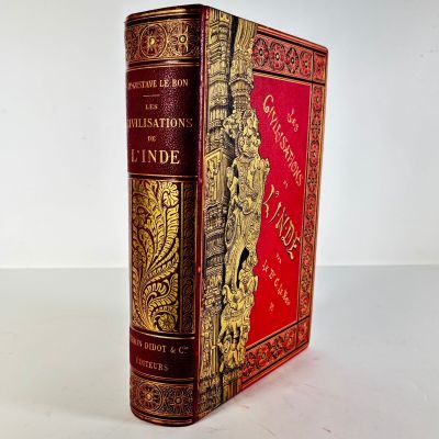 an old book sitting on top of a white table next to a white wall