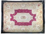 a pink and white rug with a floral design on it