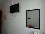 a television mounted on the wall above a radiator