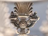 a close up of a silver object with a ring on it