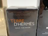 two boxes of perfume sitting next to each other on a table