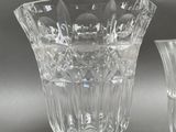 two glass vases sitting next to each other on a table