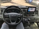 a man sitting in the driver ' s seat of a vehicle