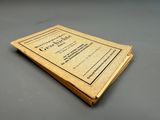 a close up of a book on a table with a black background