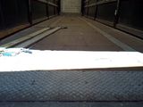 a skateboard that is sitting on the ground in the middle of a walkway