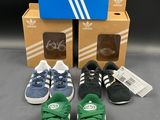 three pairs of adidas shoes and a box of shoes