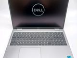 a close up of a dell laptop computer on a white surface