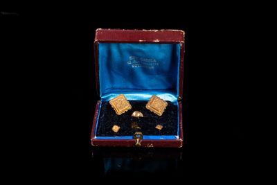 a small box with some cookies in it on a black surface