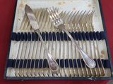 a tray with silverware on a table with a red table cloth