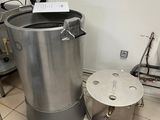 an image of a kitchen with a large pot and a small table